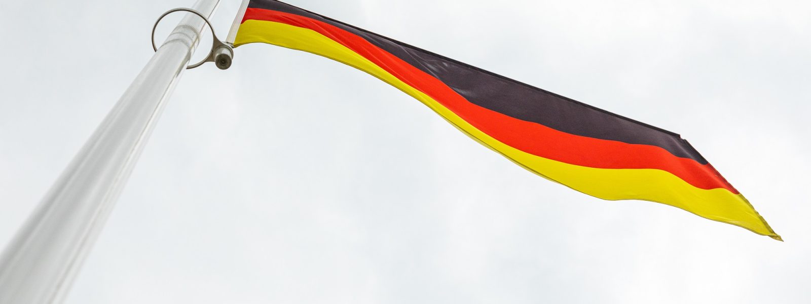 flag of Germany on a flagstuff in front of the sky